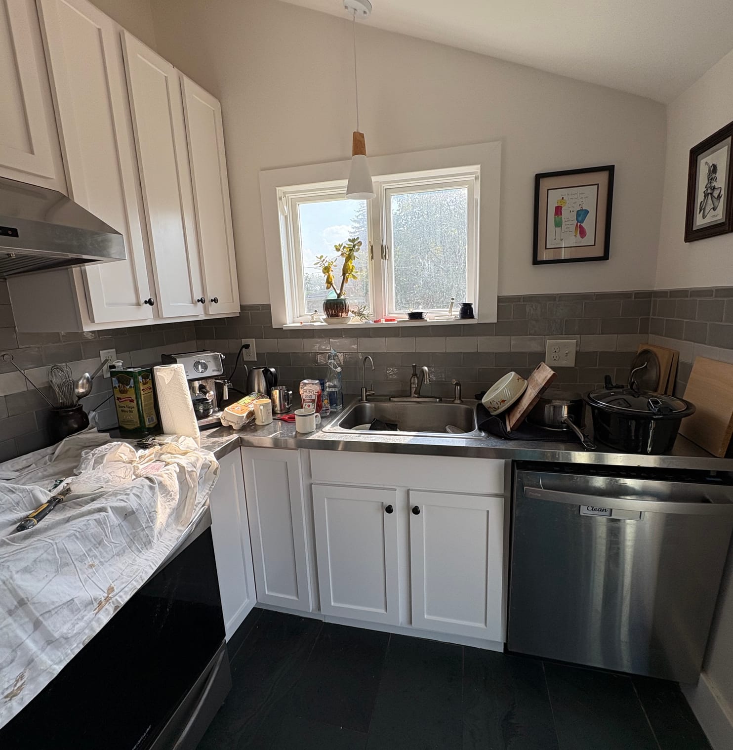 Kitchen with the cabinets painted white and the range hood boxed in