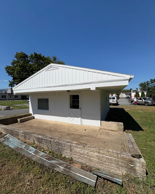 White outbuilding after exterior painting