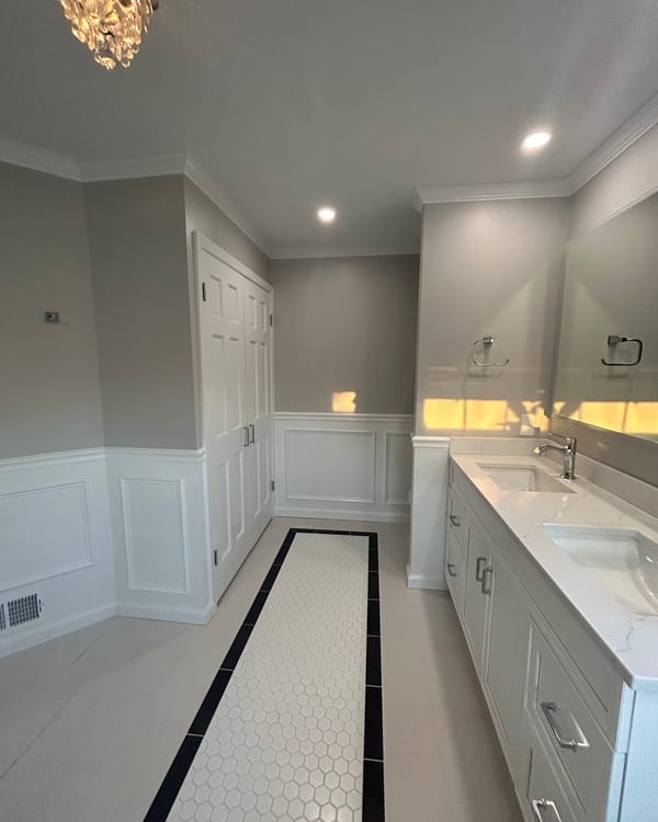 Bathroom with white wainscoting, white vanity and gray walls