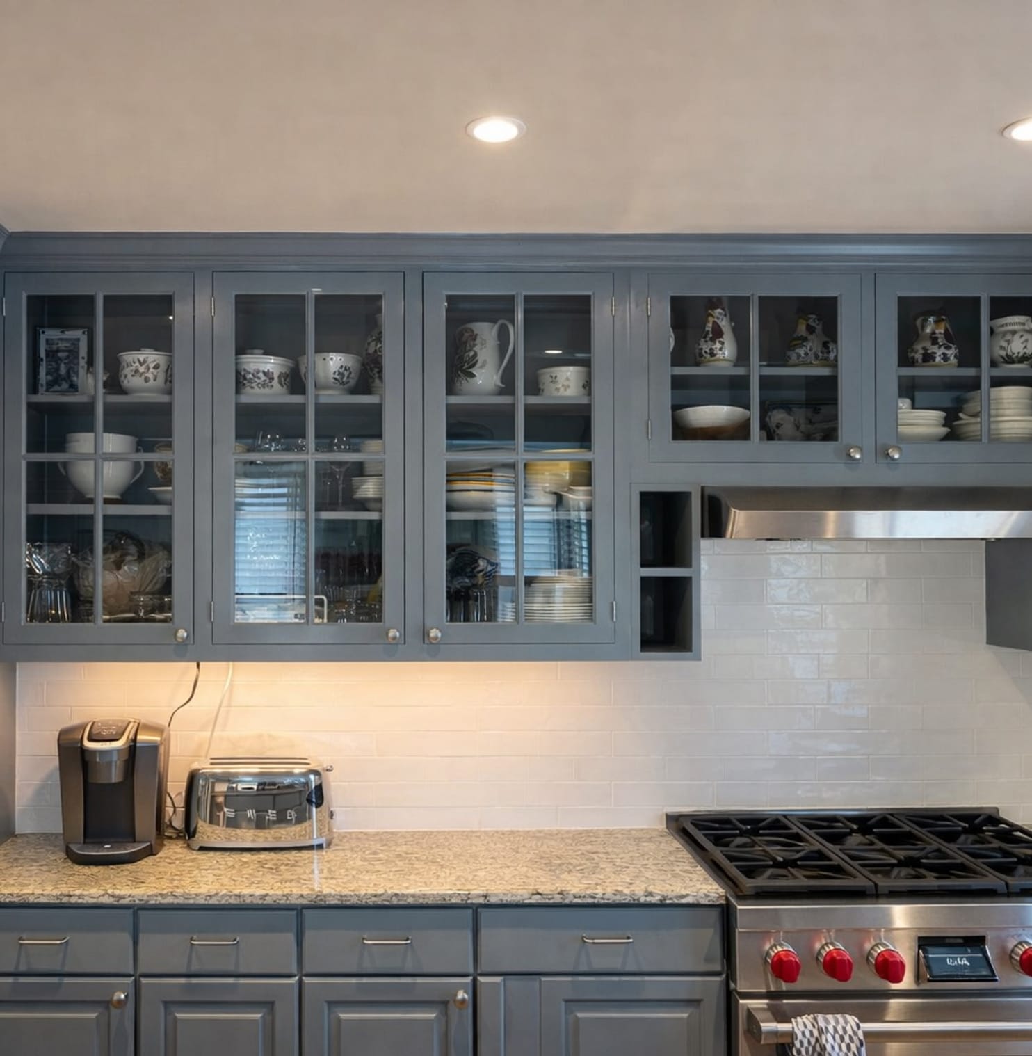 Kitchen cabinets painted blue gray with glass front doors