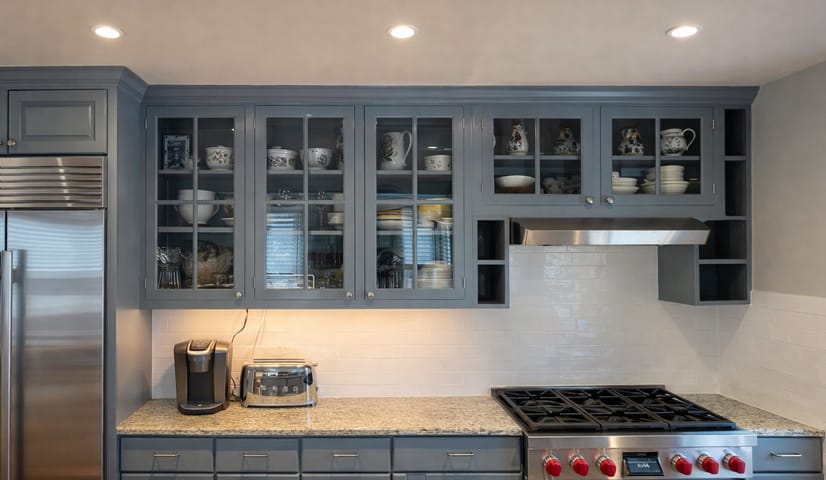 Kitchen cabinets painted blue gray with glass front doors