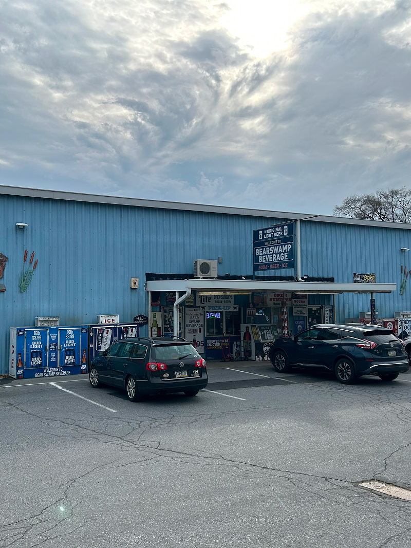 Exterior wood doors after staining — rich walnut finish on stone carriage house