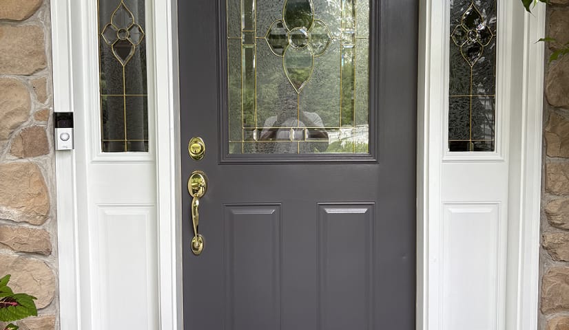 Front door repainted dark gray with white sidelights