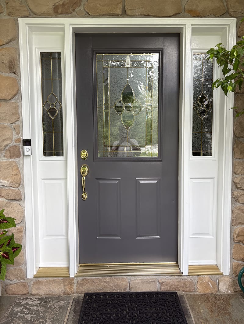 Exterior wood doors before staining — weathered and faded finish