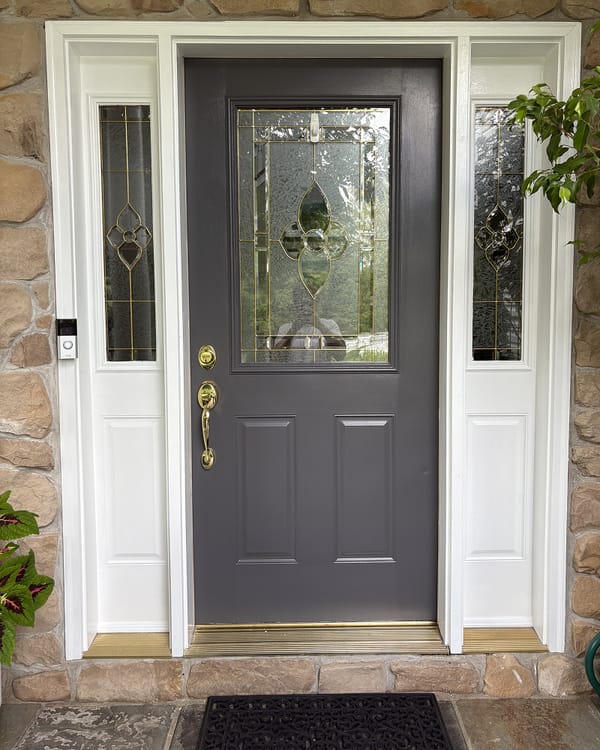 The same front door painted dark gray to match the shutters