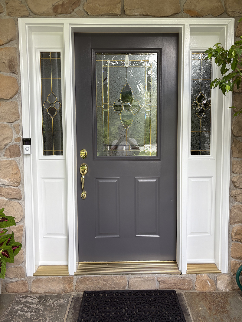 Exterior wood doors before staining — weathered and faded finish