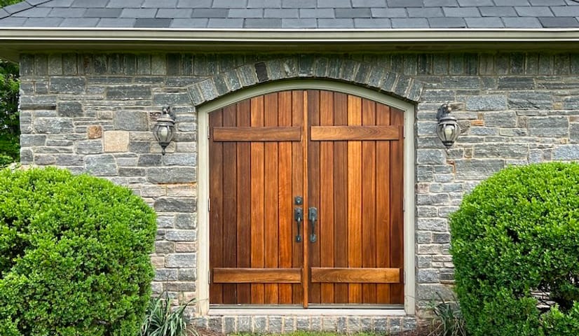 Stone pumphouse with its wood doors stained