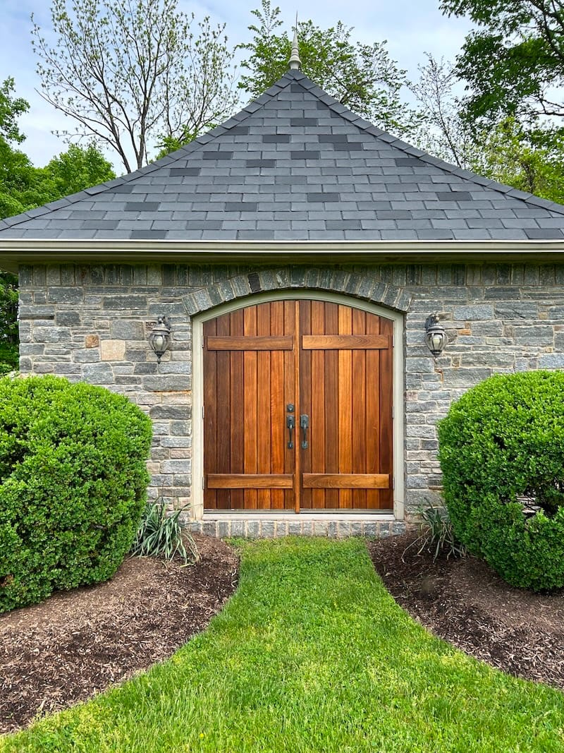 Exterior wood doors before staining — weathered and faded finish